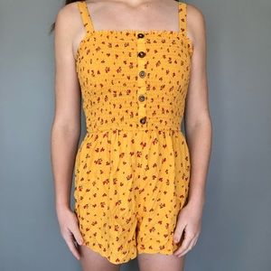 yellow button down romper with rose flower design